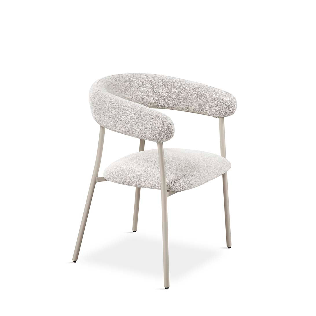 Silla tapizada en tejido bouclé claro con respaldo curvo envolvente y patas metálicas beige. Diseño escandinavo y elegante de Boutique Interiorismo.