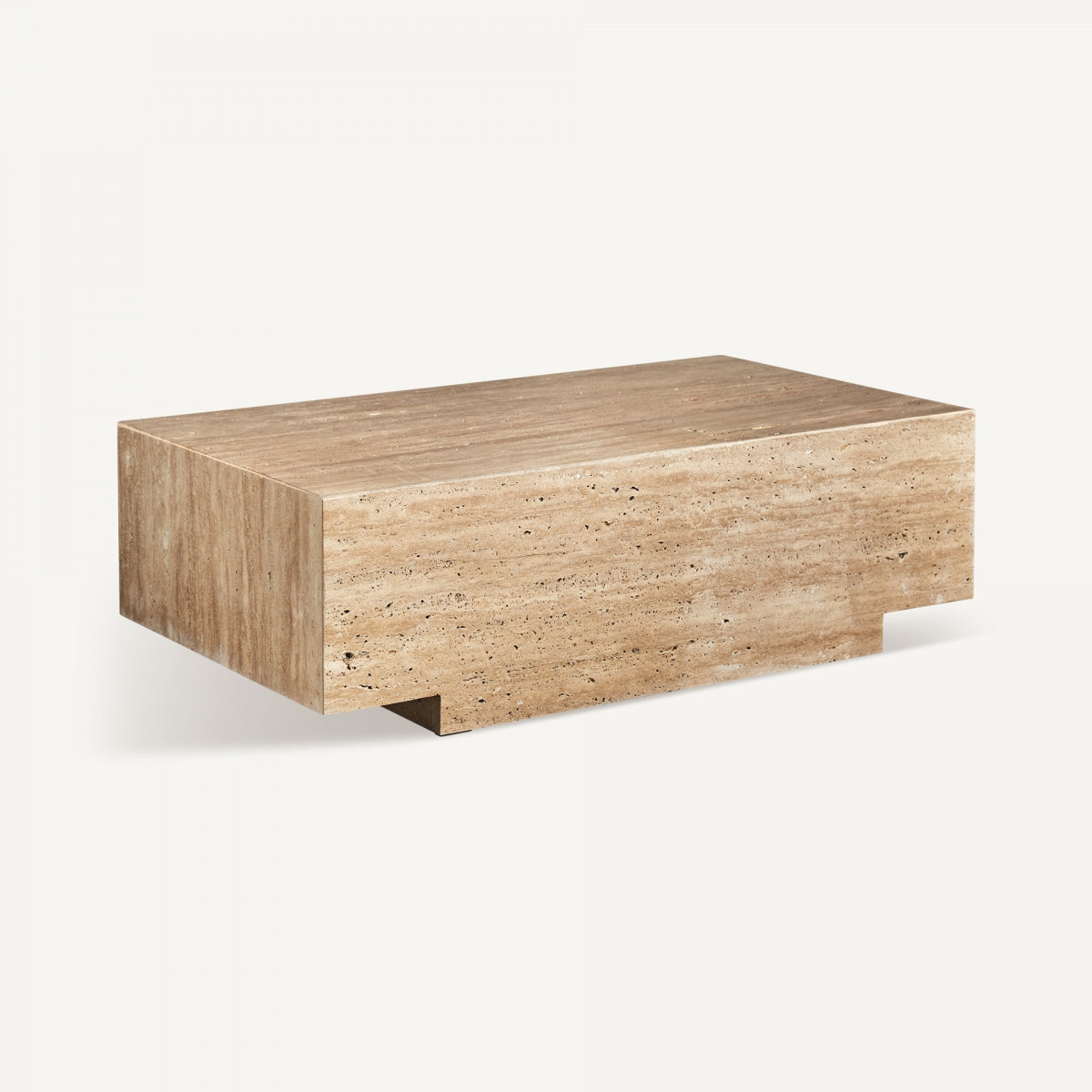 Vista lateral de la mesa NORDDAL con estructura de travertino y corte arquitectónico – estilo minimalista cálido boutique interiorismo Vical