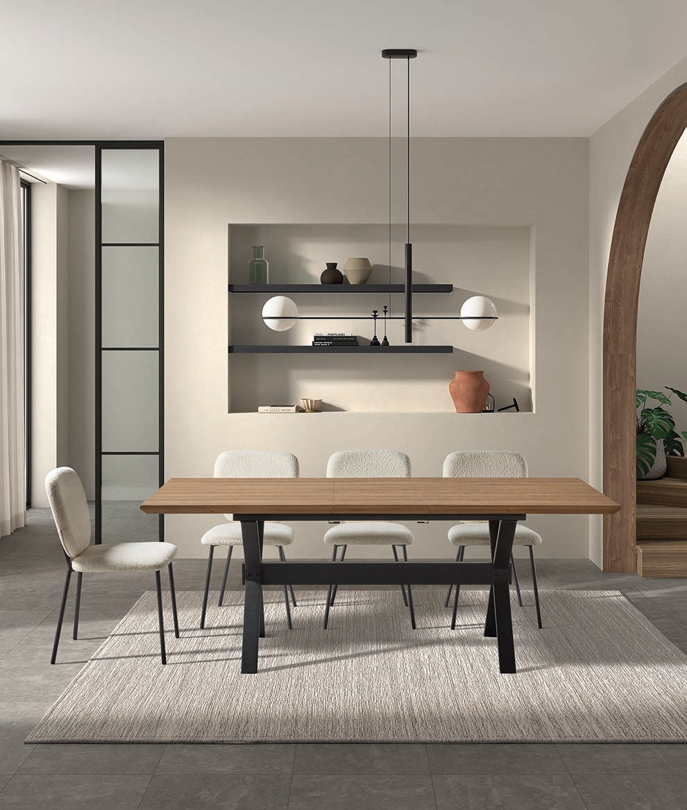 Mesa comedor extensible con acabado nogal y patas industriales negras — ideal para ambientes cálidos con personalidad de Boutique Interiorismo.
