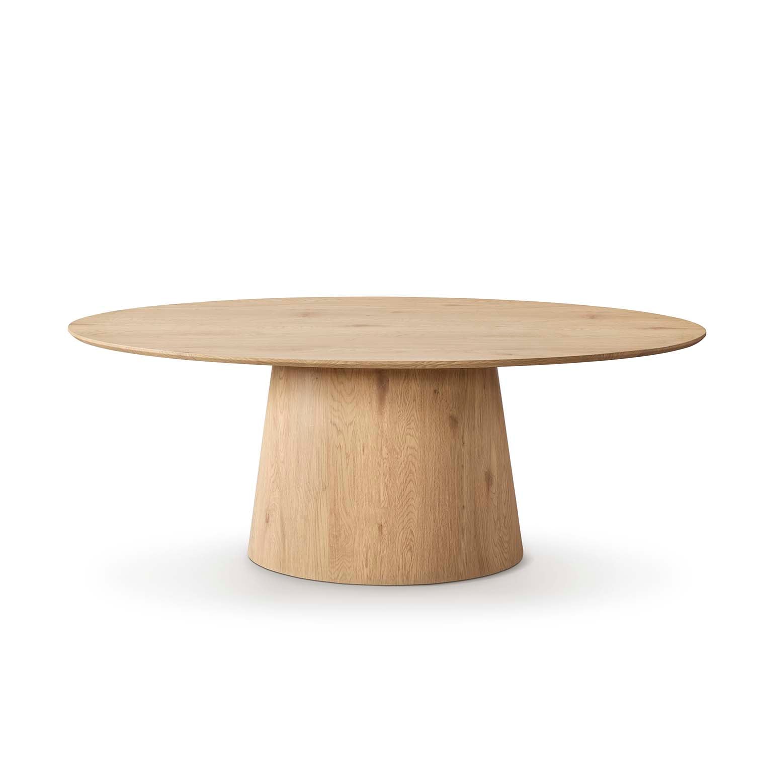 Mesa comedor ovalada en madera clara vista lateral — ideal para ambientes serenos y naturales de Boutique Interiorismo.

