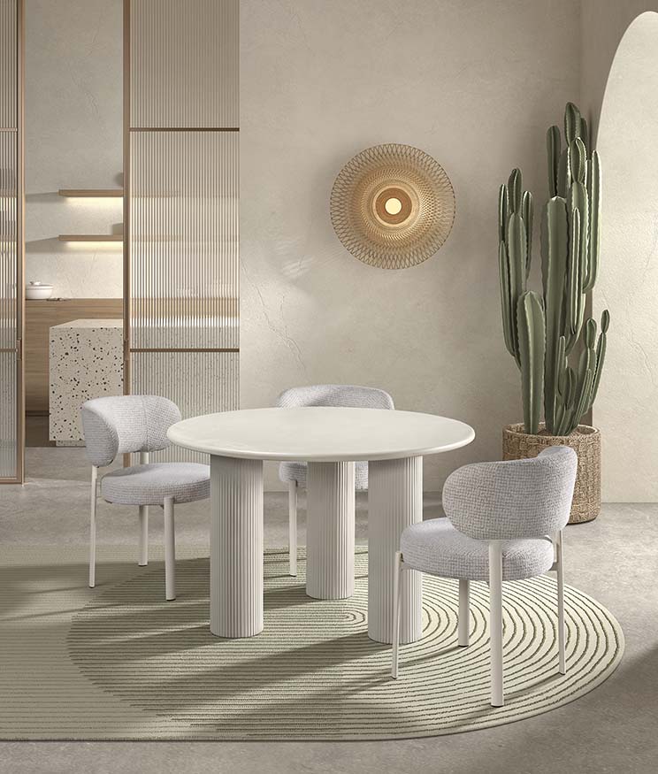 Mesa comedor porcelánica blanca con base cruzada negra — contraste de materiales y diseño vanguardista de Boutique Interiorismo.

