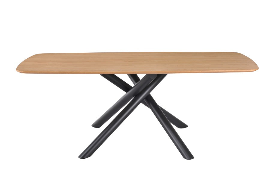 Mesa de comedor rectangular de madera natural con patas metálicas tubulares entrelazadas en color negro, diseño moderno y escultórico ideal para interiores con carácter. Boutique Interiorismo.