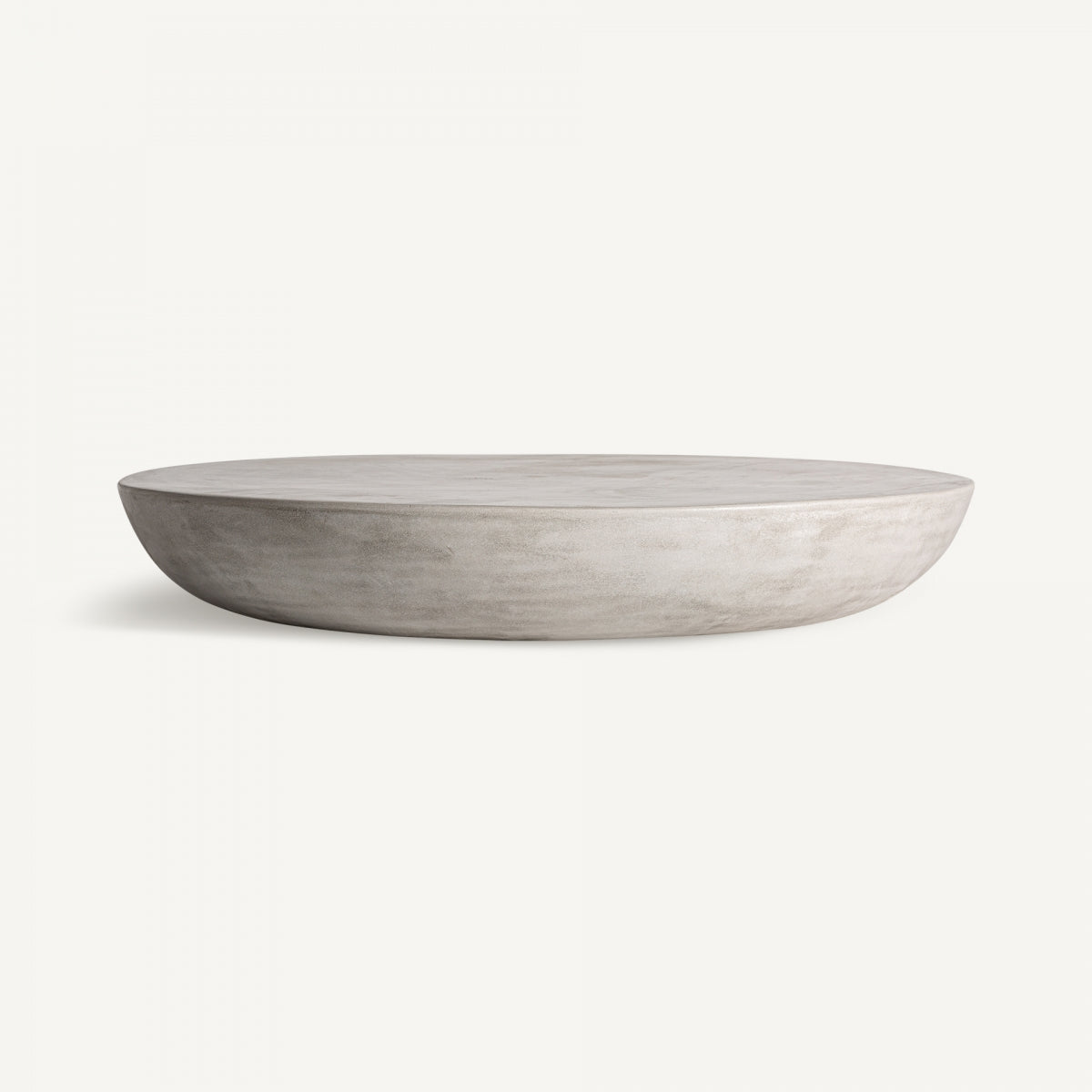 Mesa de centro CLESS en gres gris de forma redonda y baja, estilo minimalista y elegante