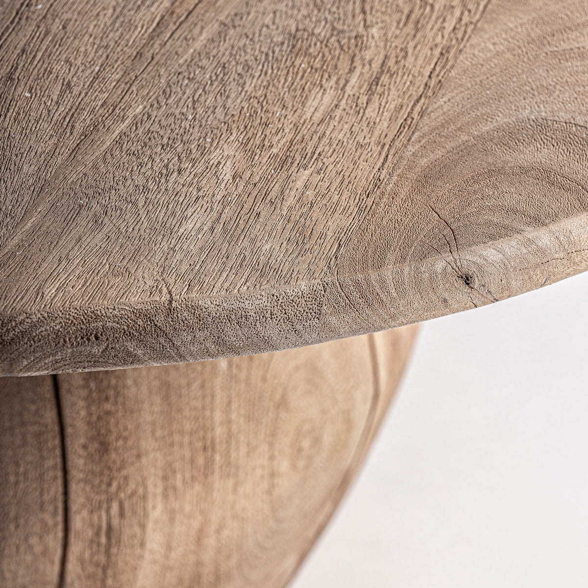 Detalle de la tapa redonda de madera, vetas visibles y acabado orgánico