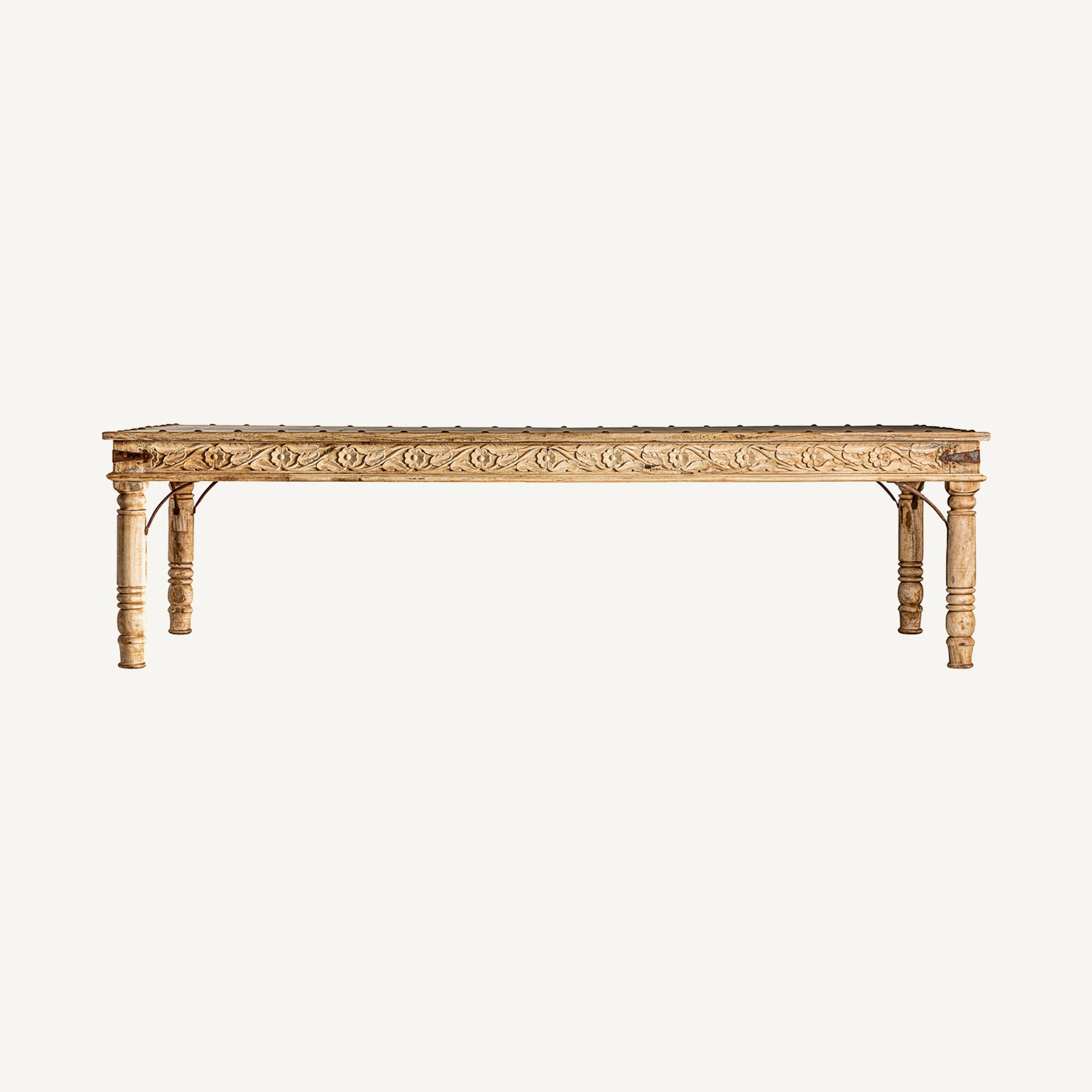 Vista frontal de mesa de comedor rectangular de madera tallada en acabado natural, estilo rústico vintage.
