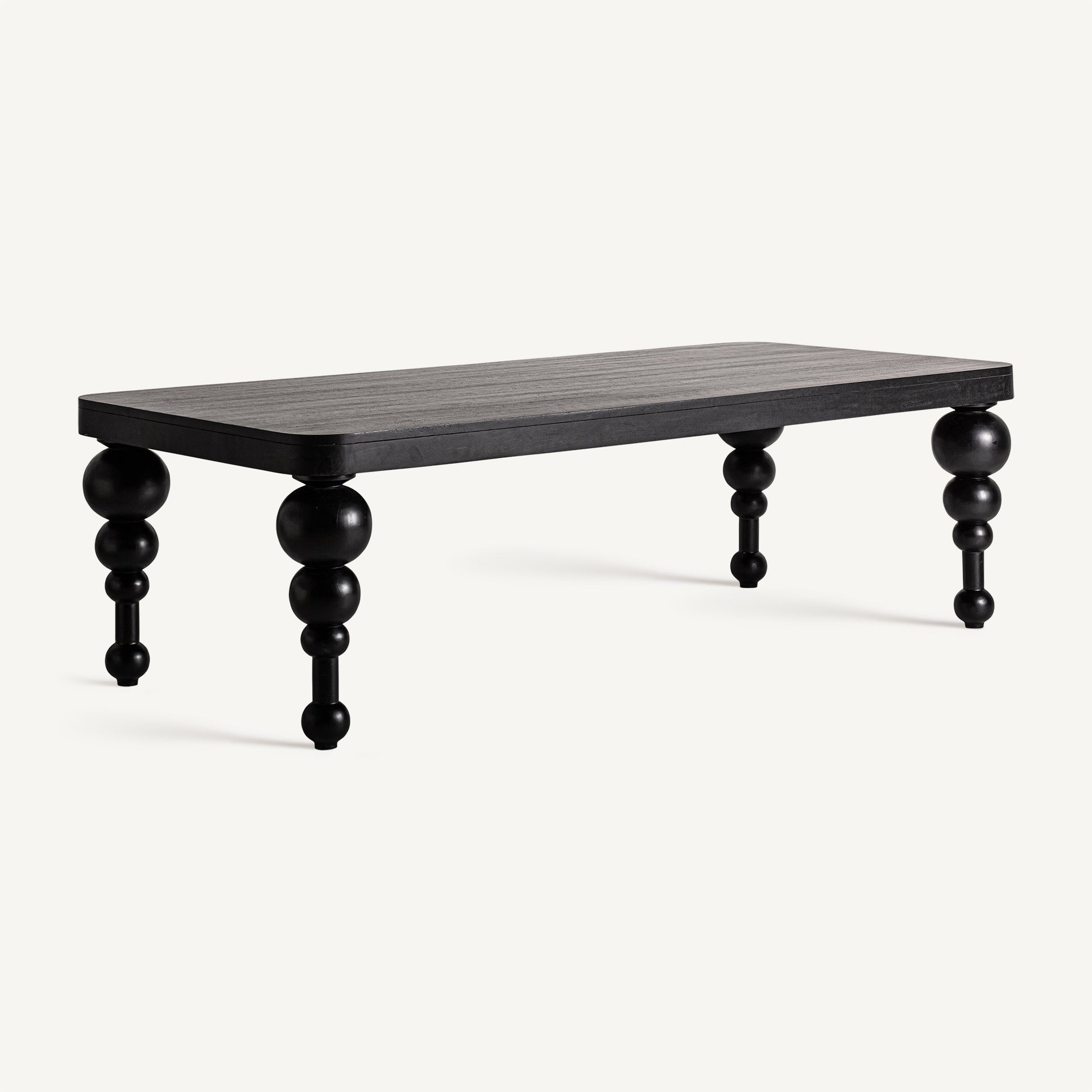 Mesa centro ZENIVA con patas decorativas y acabado negro mate, estilo contemporáneo – vista lateral