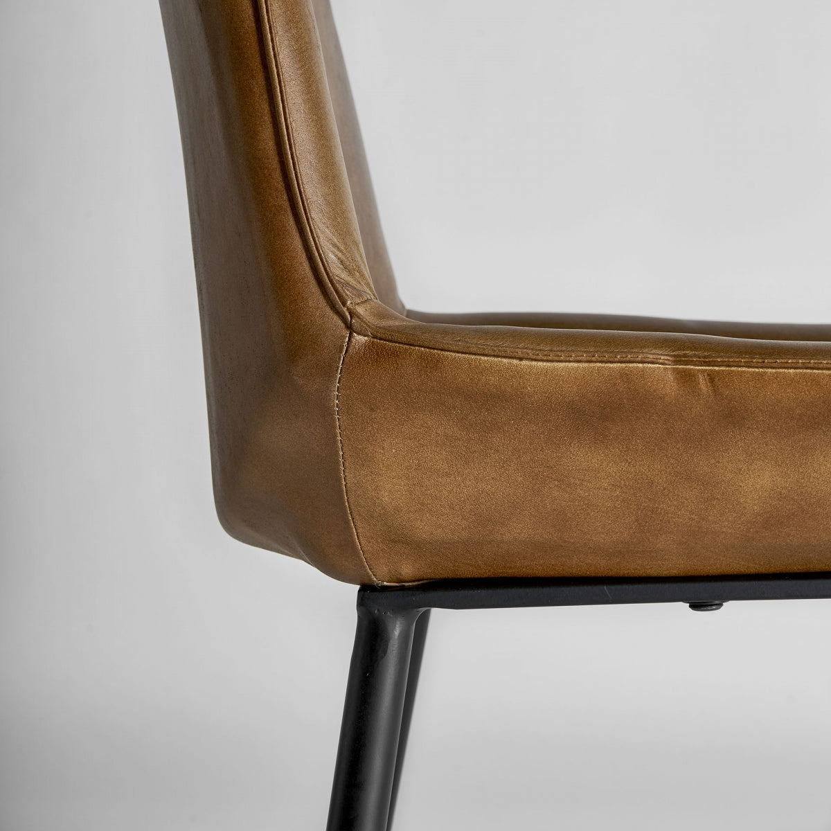 Costura lateral en cuero camel con acabado artesanal y líneas definidas