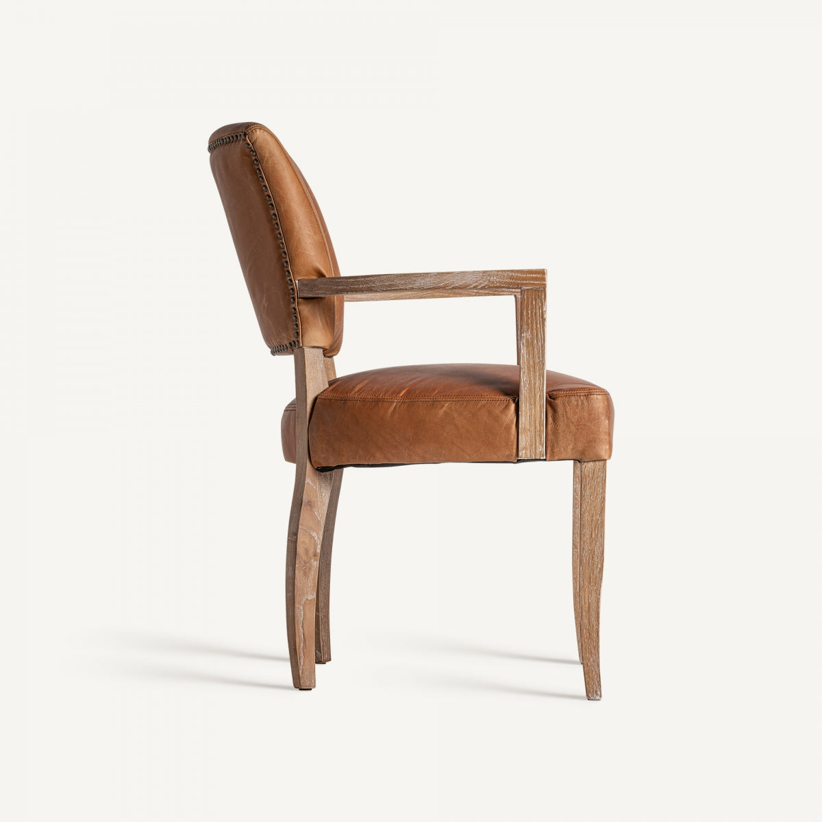 Vista lateral de la silla de cuero marrón con estructura de madera, diseño ergonómico con brazos definidos.