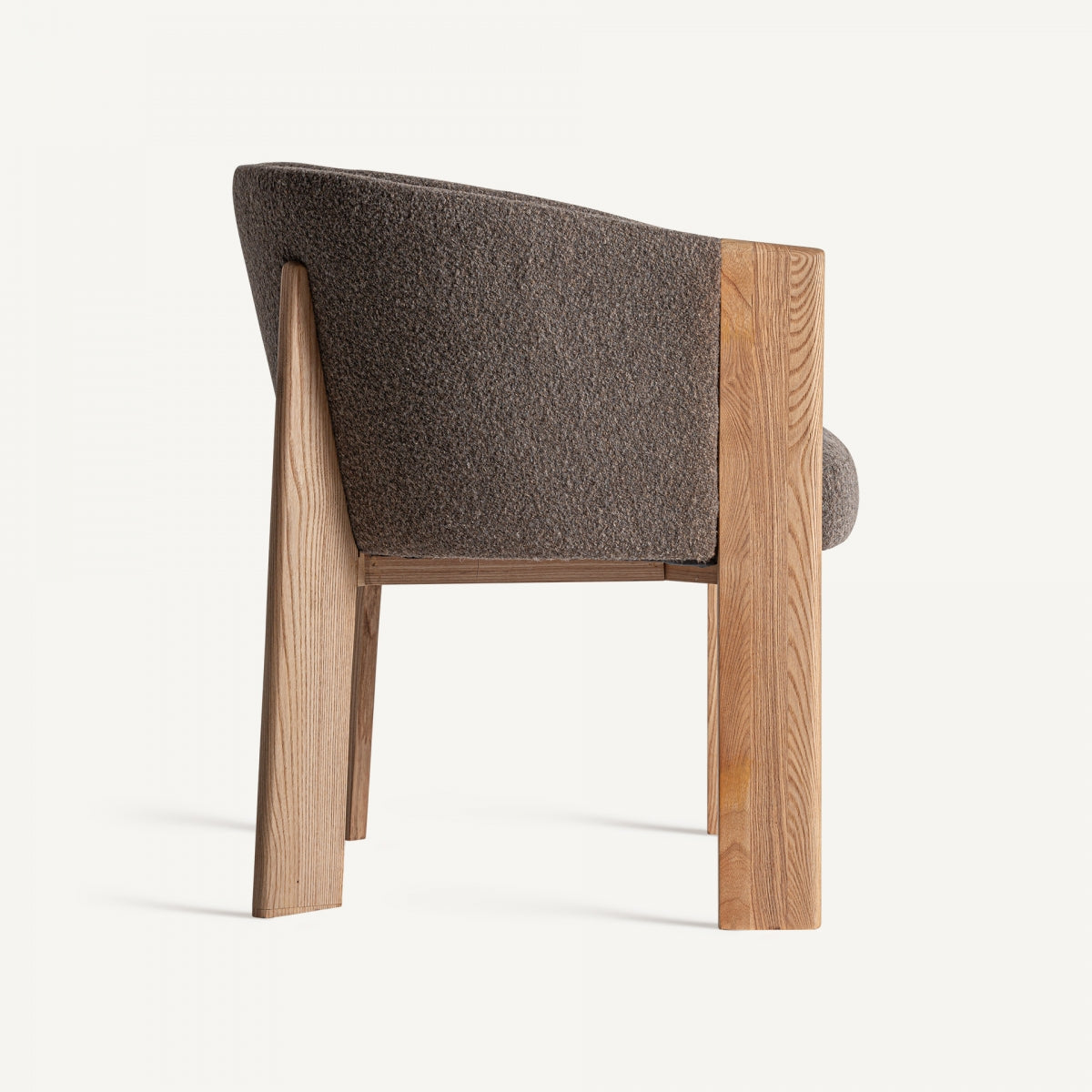 Vista trasera de silla en ratán oscuro con estructura envolvente y diseño armónico
