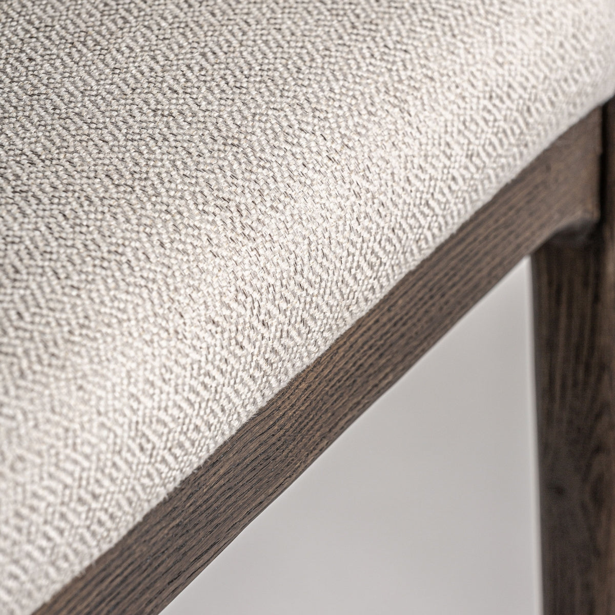 Unión entre estructura de madera y asiento tapizado, detalle artesanal de alta calidad