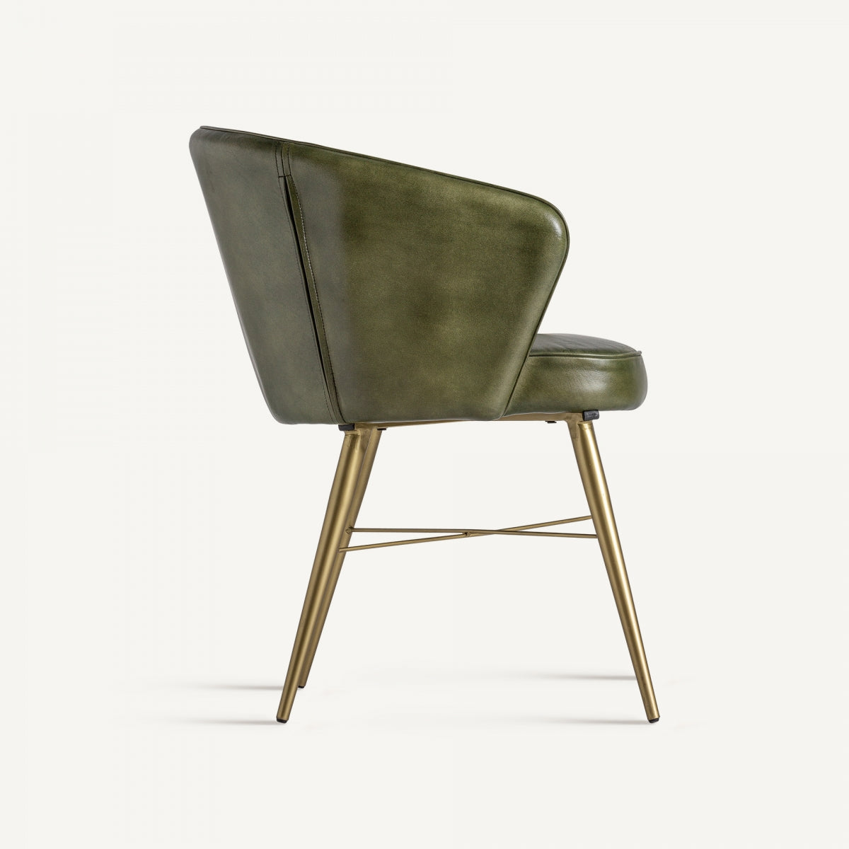 Perfil lateral del sillón de piel verde con asiento mullido y diseño moderno