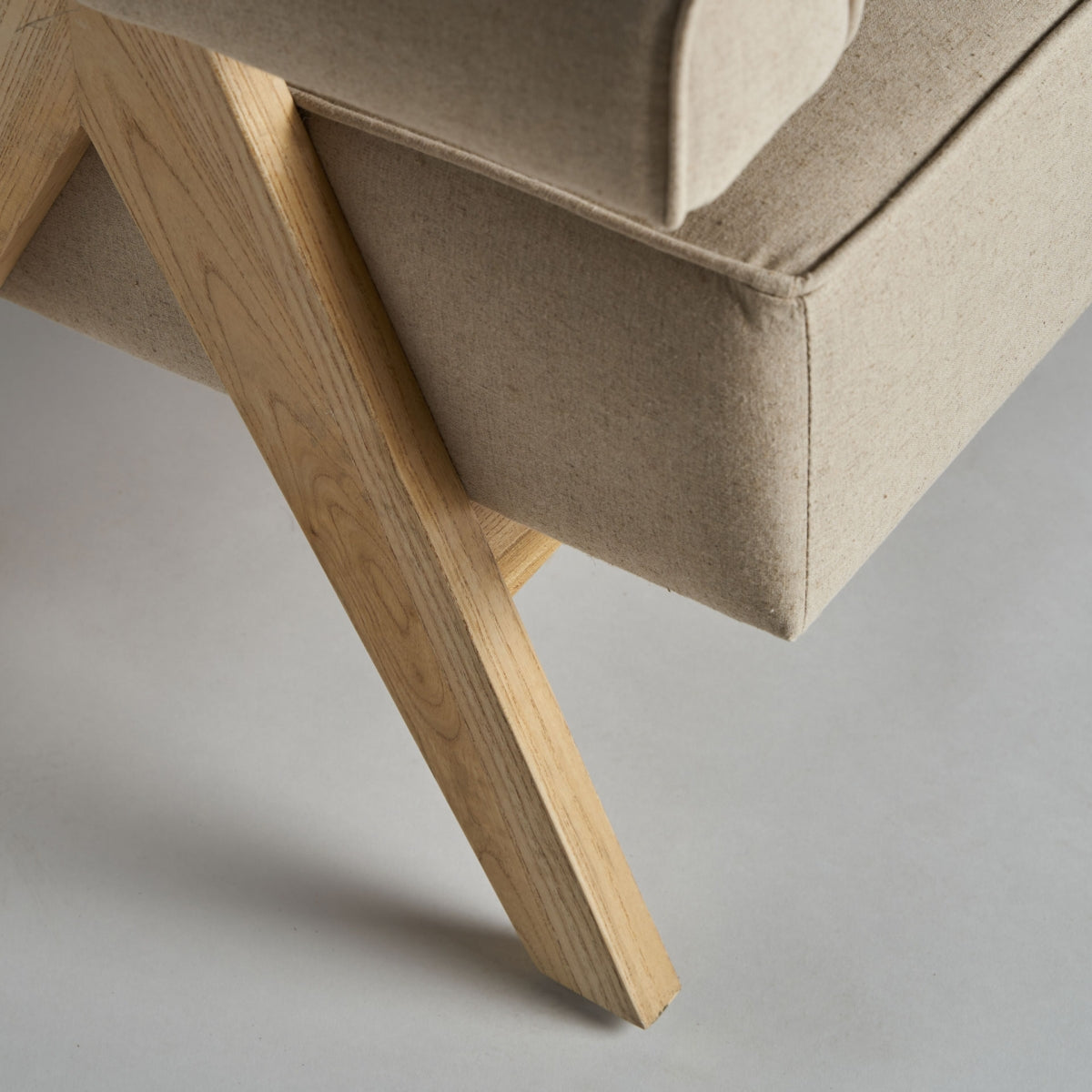 Detalle de la pata de madera clara del sillón con estructura en forma de A, diseño geométrico escandinavo, boutique interiorismo vical