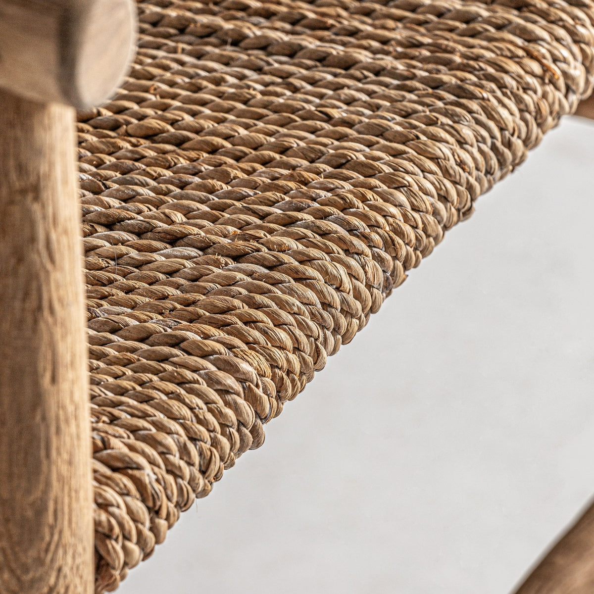 Plano detalle del asiento trenzado en fibra natural, estilo boho y trabajo artesanal