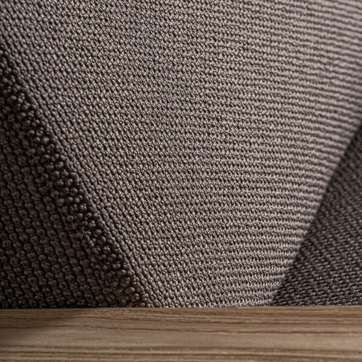 Vista inferior del asiento mostrando base robusta de madera y acabado textil de alta calidad