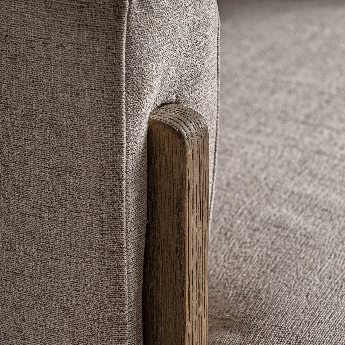 Detalle de la unión entre el tapizado bouclé y la estructura de madera de roble