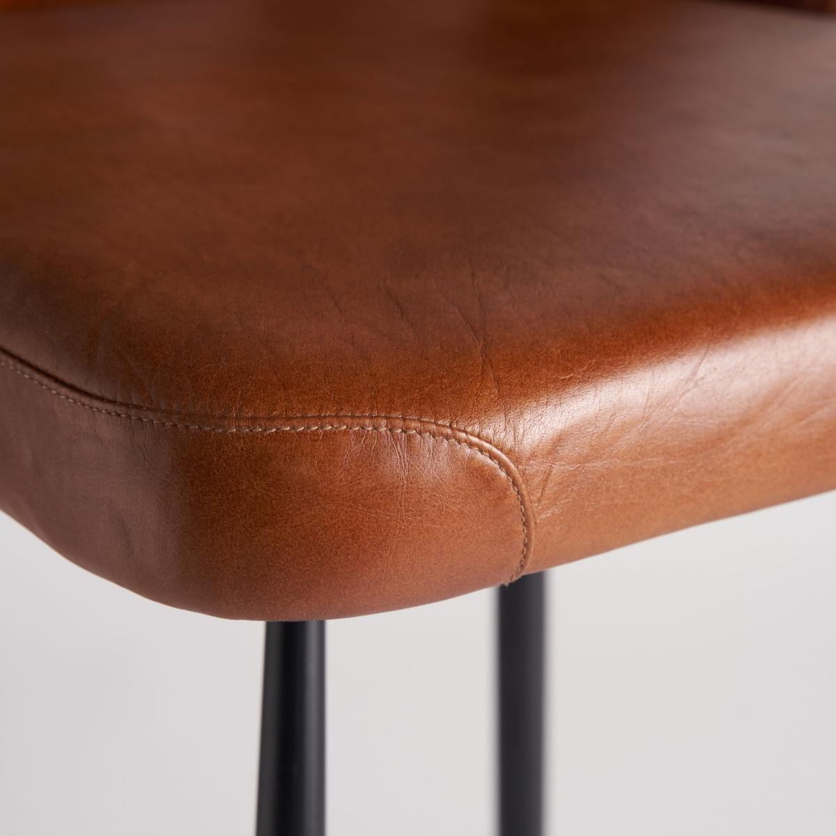 Primer plano de la esquina del asiento de piel marrón, costuras marcadas y textura natural - boutique_interiorismo_vical